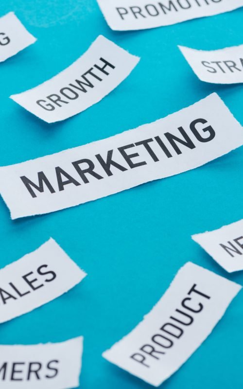 marketing components on pieces of paper on blue