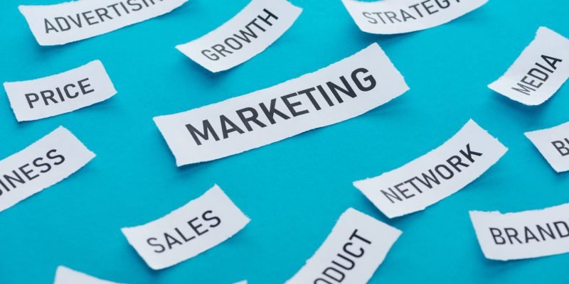 marketing components on pieces of paper on blue